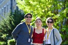 Daughter and 2 parents smiling at the camera