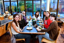 Family sitting and eating in New Dorm Dining Hall